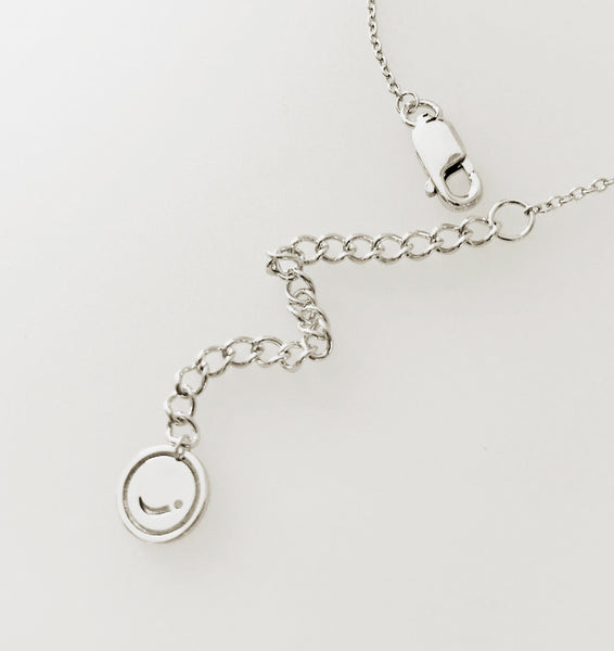 Joulala brand tag on baby komodo dragon silver necklace.